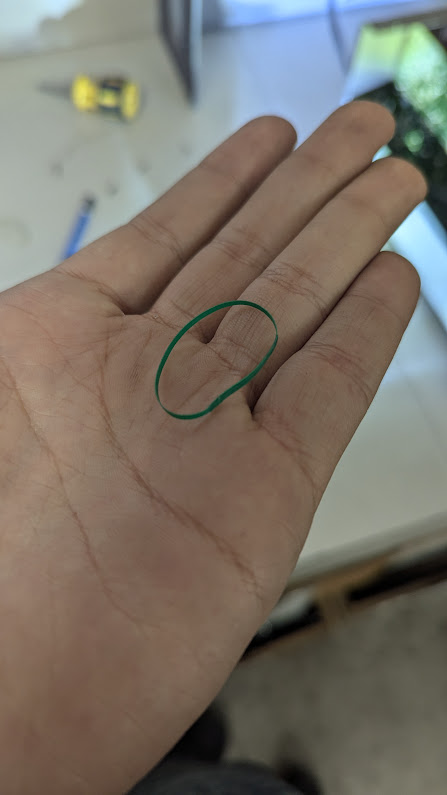 An rubber loop made from green electrical tape that looks so much like a regular green rubber band.